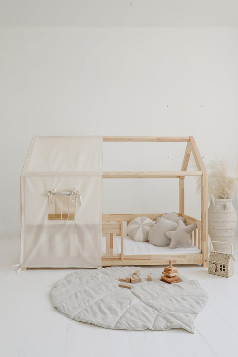 5. Sand leaf playmat in minimalist nursery with wooden bed and neutral decor