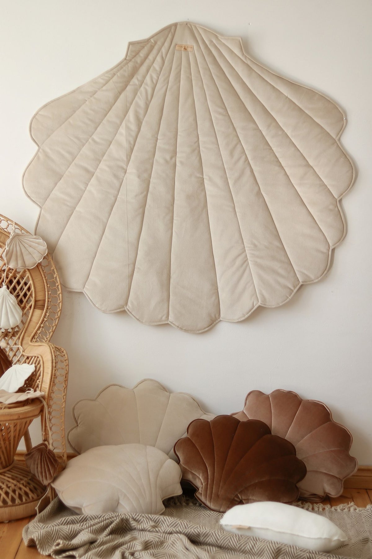 11. Beige ginkgo leaf-shaped playmat on wall with cushions and wicker chair