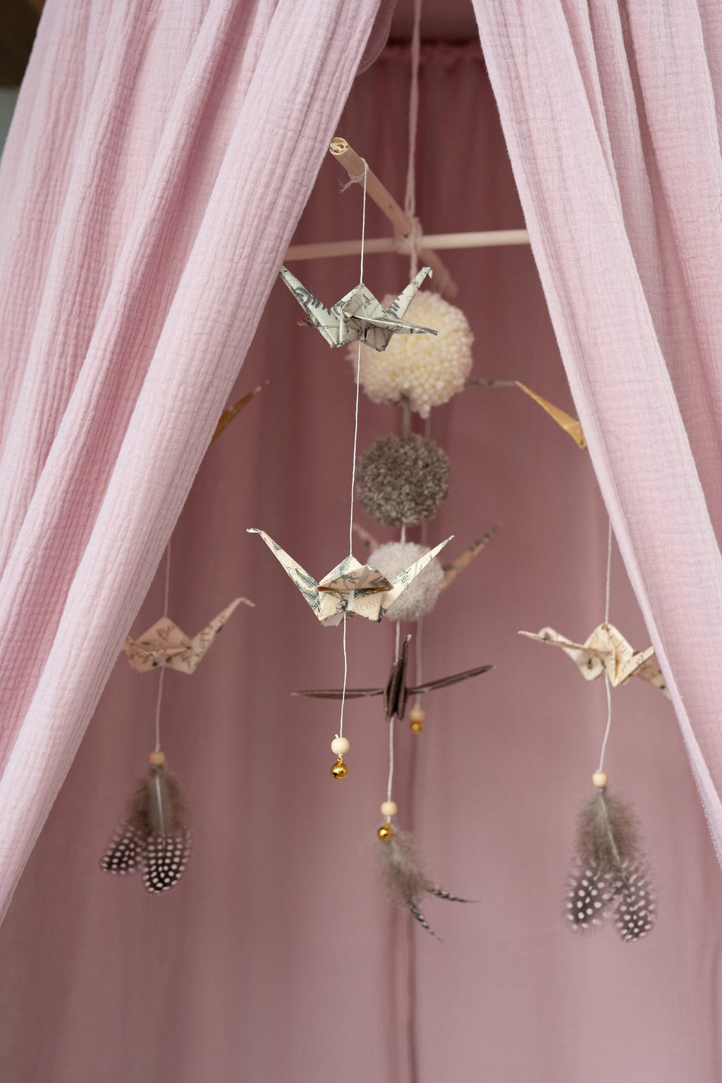 6. Close-up of hanging ornaments inside pink canopy