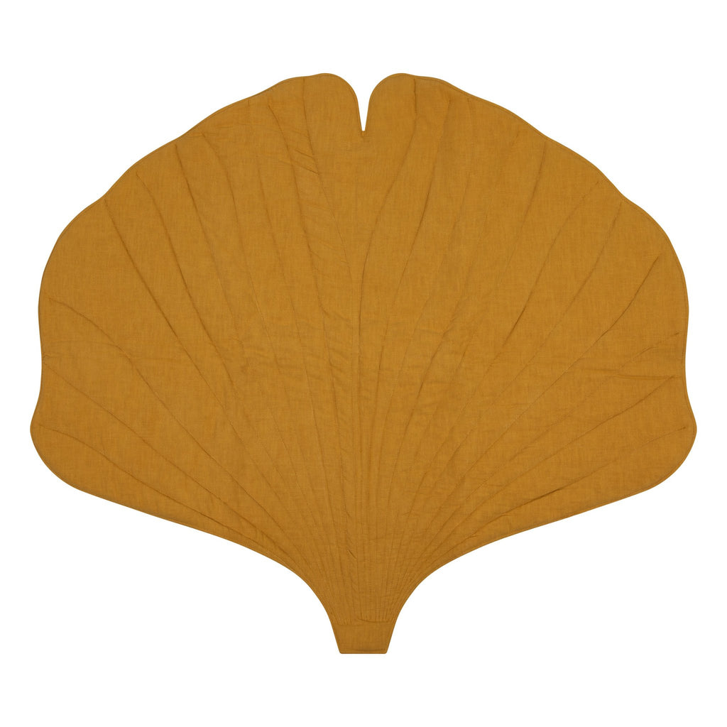 2. Mango-colored ginkgo leaf-shaped playmat made from organic cotton and linen on a white background