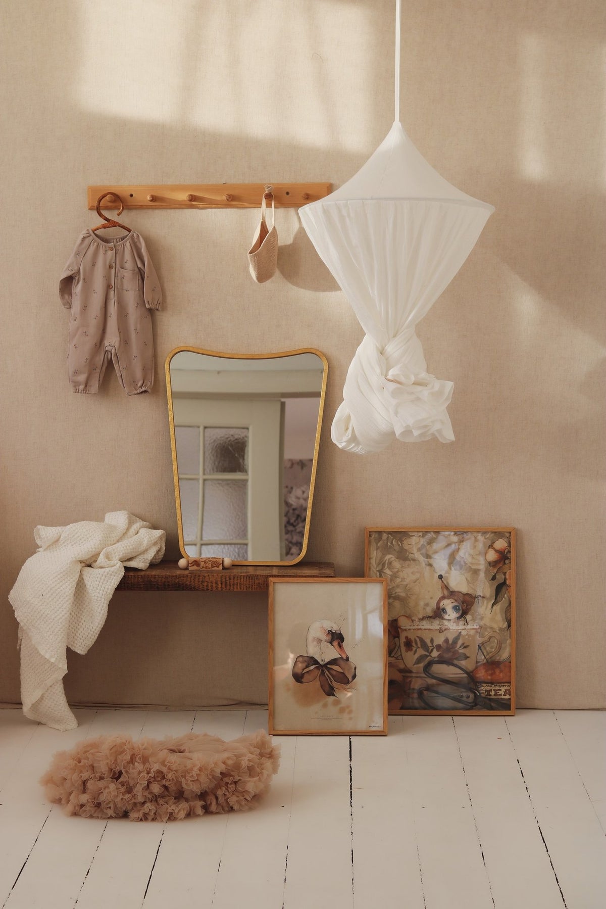 1. Cream cotton canopy tied up in a stylish nursery setting with mirror and artwork