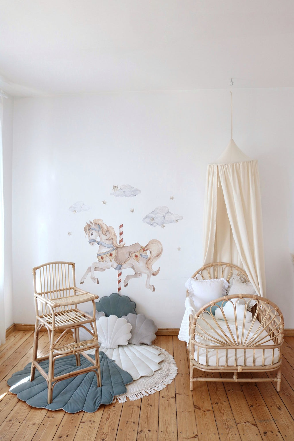 8. Nursery with organic cotton canopy, rattan crib, and horse wall art