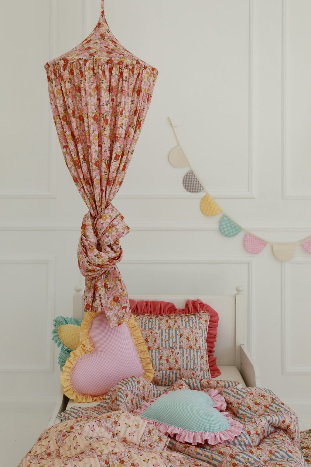 8. Floral canopy with cushions and garland in a bright room