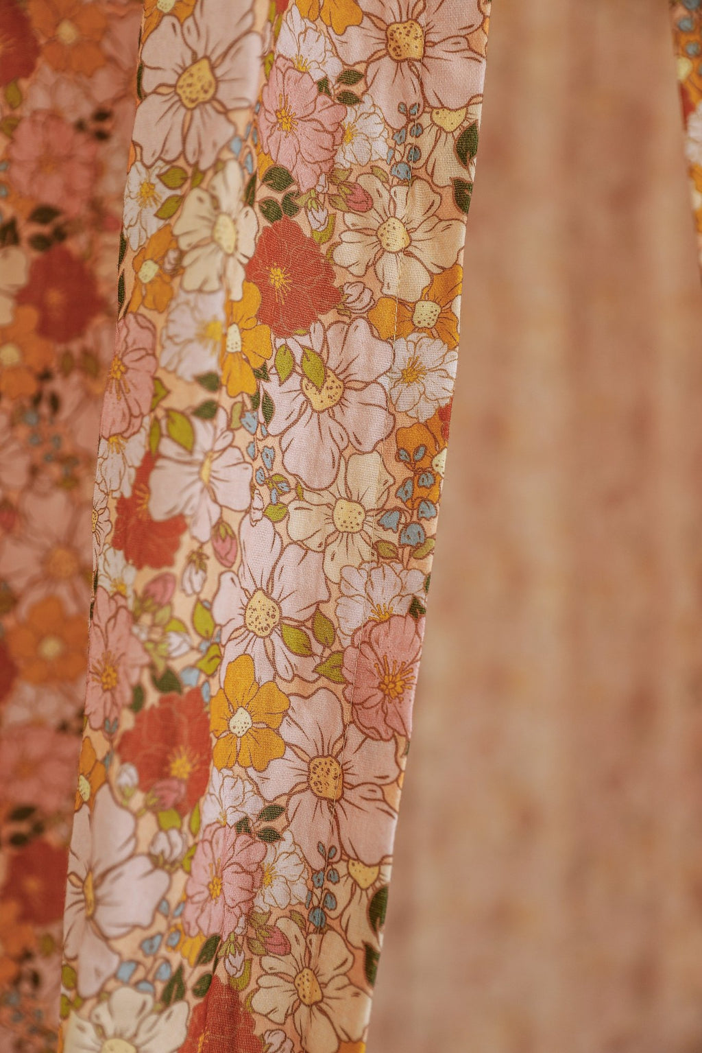 10. Close-up of floral fabric in pink and orange hues