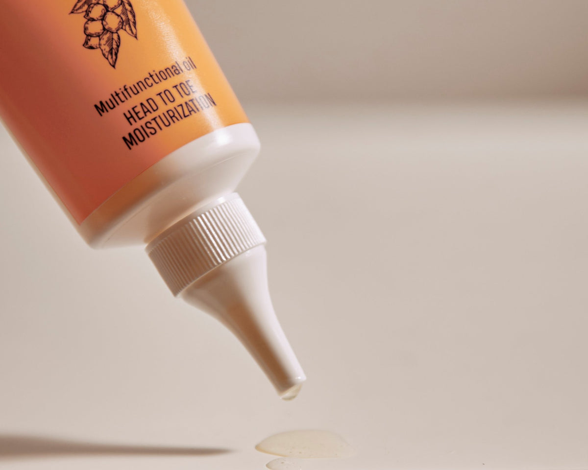 3. Close-up of Nurme 100% Pure Shea Oil being dispensed from twist cap tube onto surface