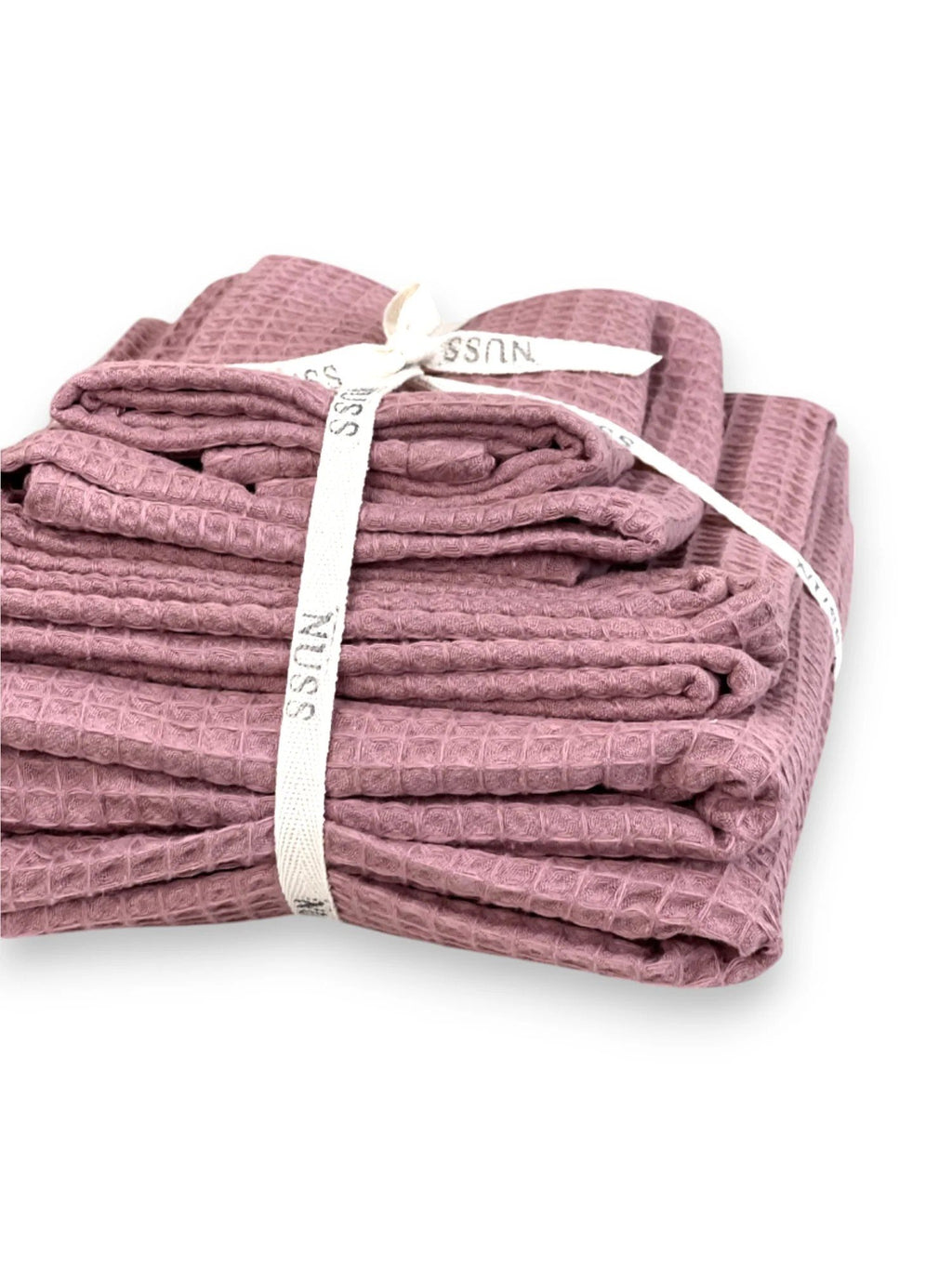 8. Folded old pink waffle cotton towels tied with Nuss ribbon, highlighting packaging