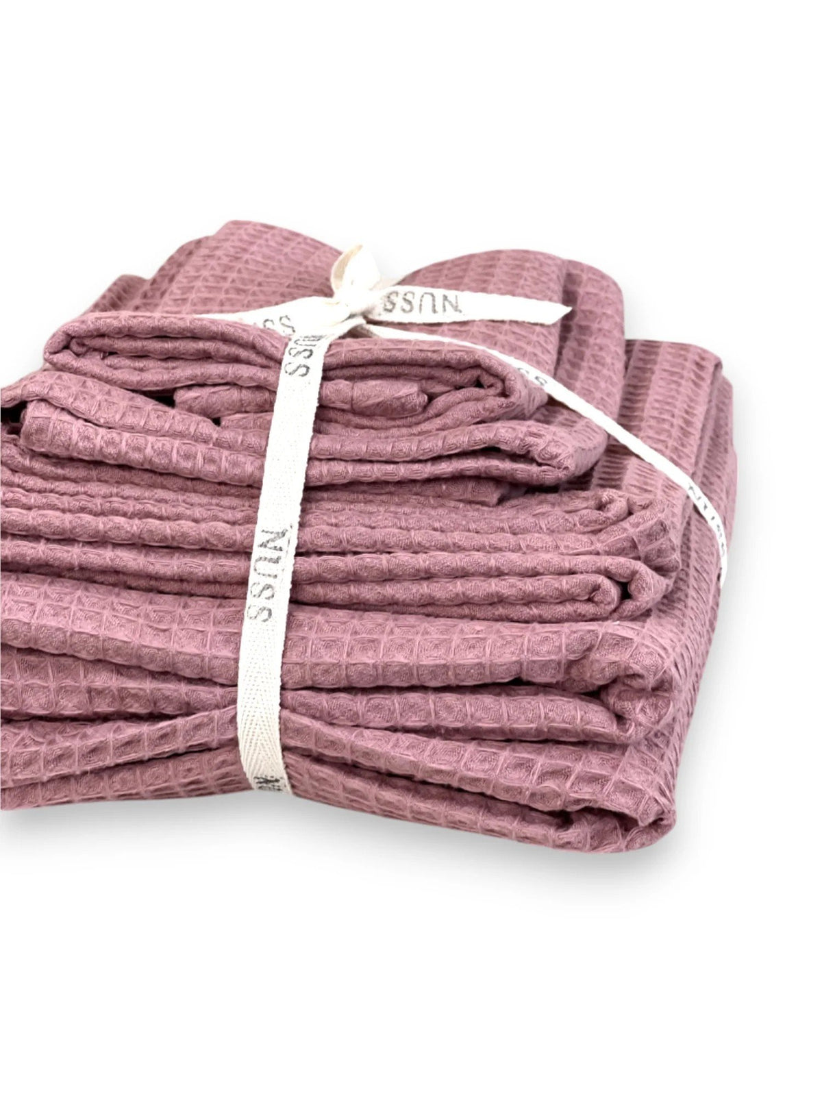 8. Folded old pink waffle cotton towels tied with Nuss ribbon, highlighting packaging