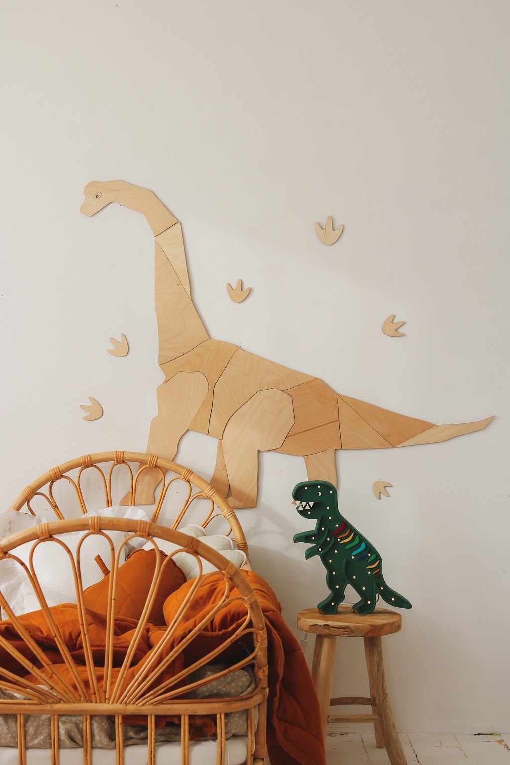 1. Wooden origami diplodocus wall decoration in child's room with rattan chair and dinosaur toy