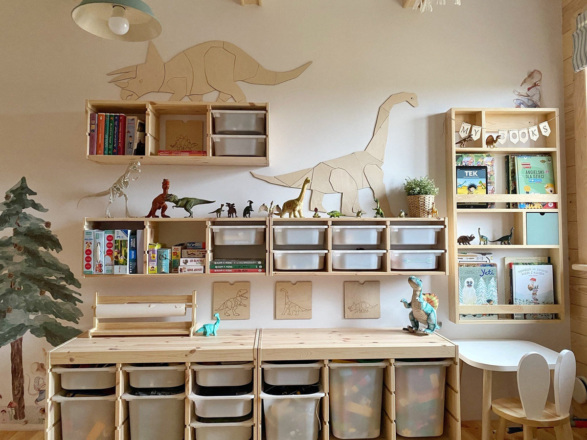 4. Wooden diplodocus wall art in playroom with bookshelves and toy dinosaurs
