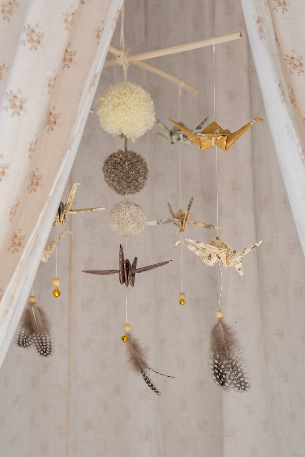 8. Close-up of Moi Mili origami mobile with paper cranes and pompoms inside floral canopy