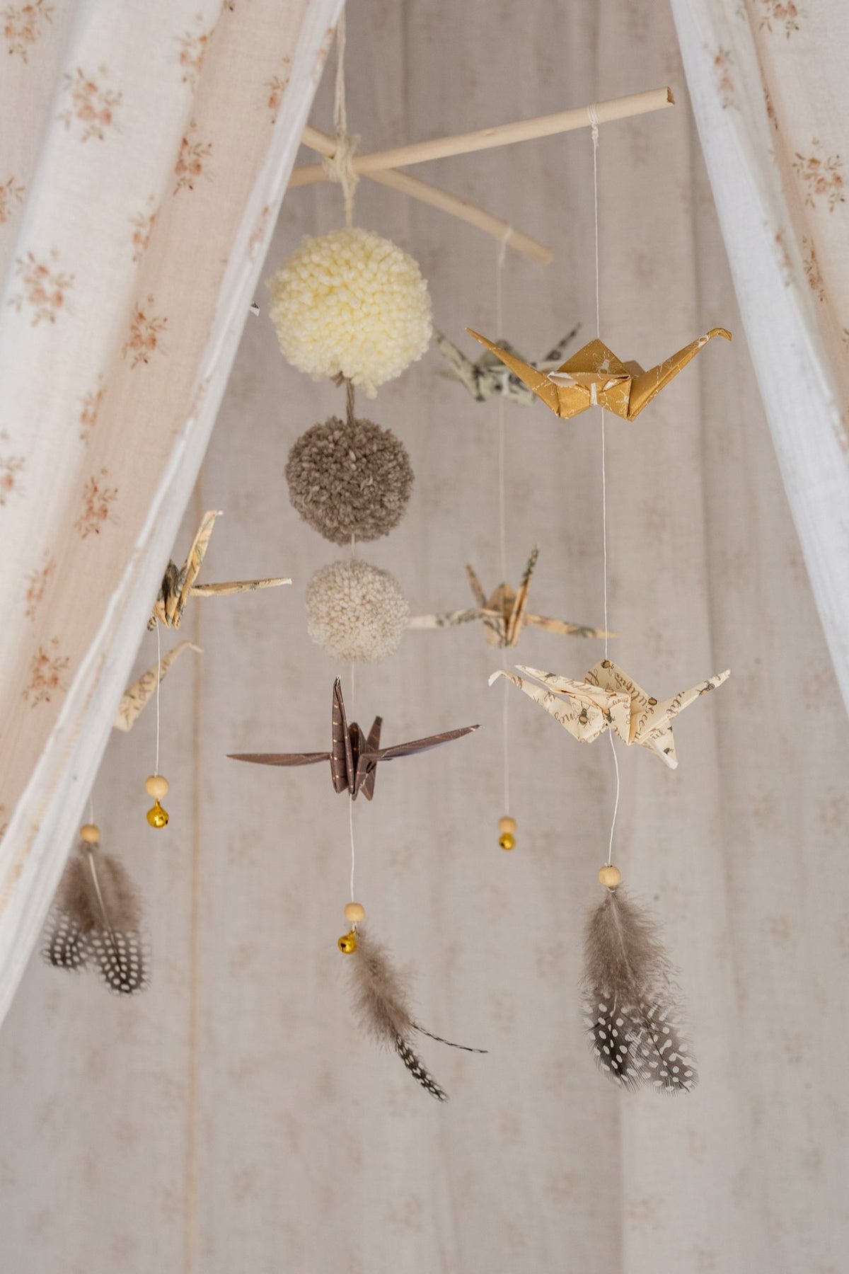 8. Close-up of Moi Mili origami mobile with paper cranes and pompoms inside floral canopy
