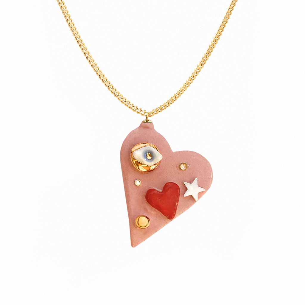 3. Studio image of SCULP All You Need Is Love necklace featuring ceramic heart pendant with 24K gold lustre and Swarovski crystal