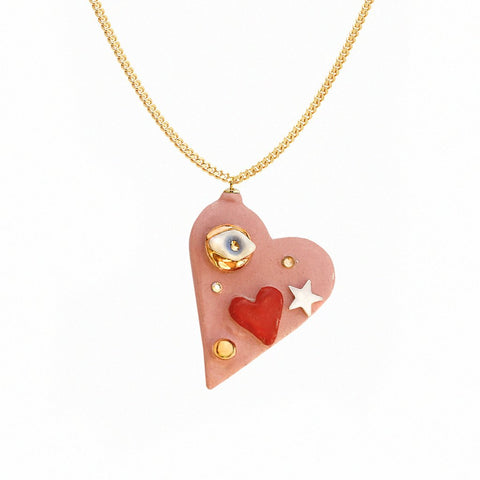 3. Studio image of SCULP All You Need Is Love necklace featuring ceramic heart pendant with 24K gold lustre and Swarovski crystal
