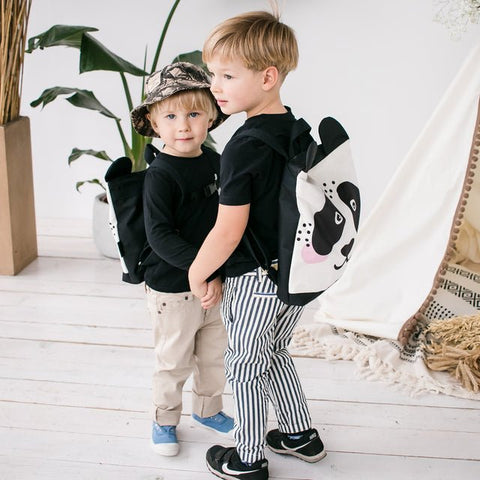 2. Boys posing with Muni Panda backpacks, showcasing the fun design in a lifestyle setting