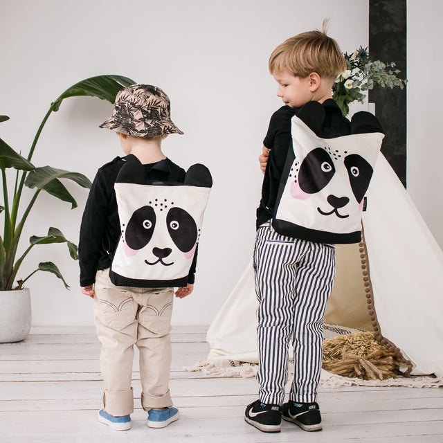 4. Back view of boys wearing Muni Panda backpacks, showing adjustable straps and design