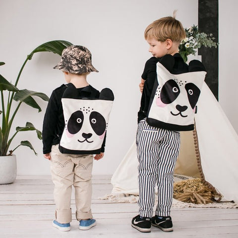 4. Back view of boys wearing Muni Panda backpacks, showing adjustable straps and design