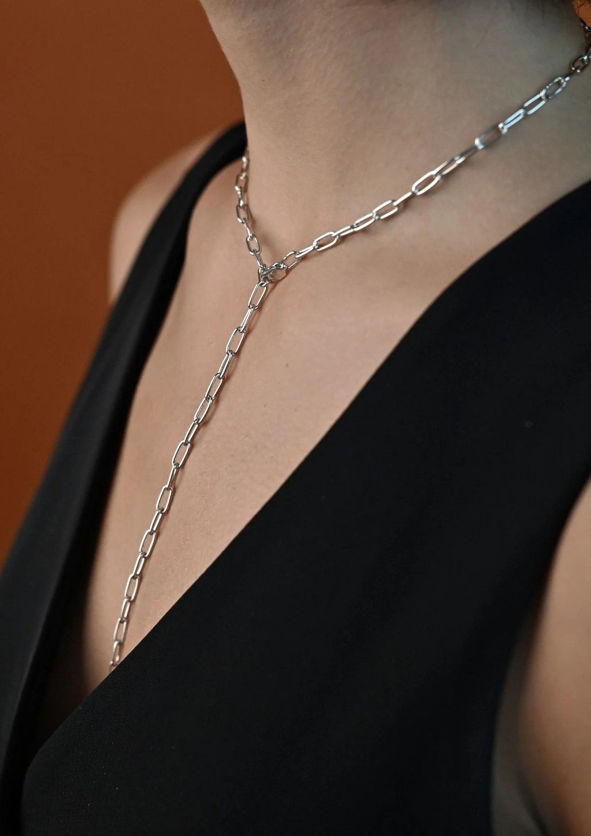 11. Woman wearing silver Y-shaped necklace with black V-neck top