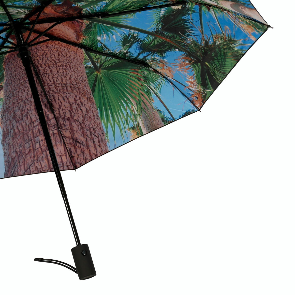6. Close-up of Paradise Umbrella with tropical print, focusing on palm tree design and handle