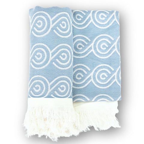 2. Blue bamboo towel with white swirl pattern and fringed edges, folded on a white background