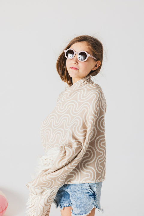 1. Girl wearing beige Patulove bamboo towel with hood and sunglasses in a studio setting