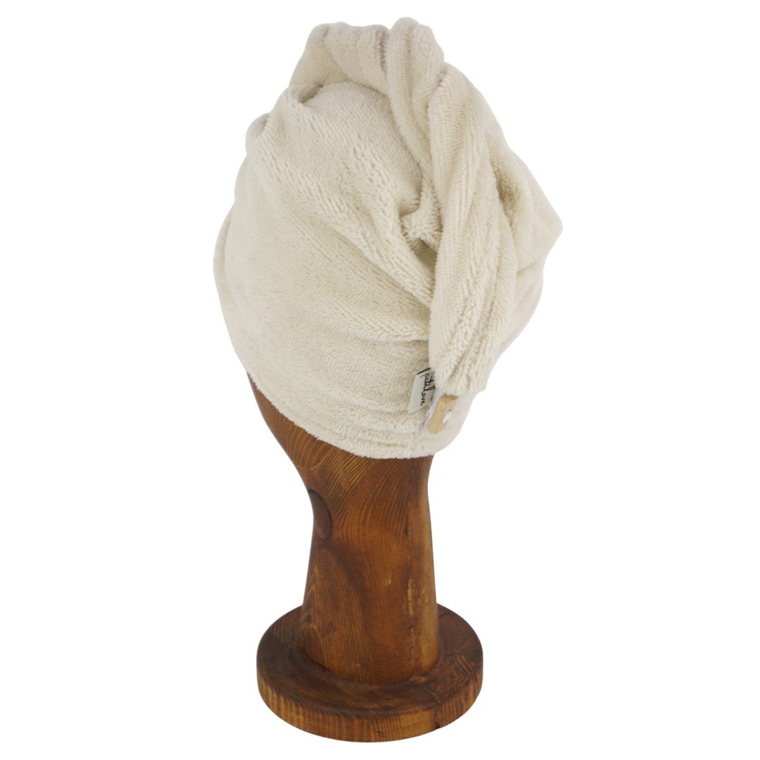 7. Cream bamboo-cotton hair turban on wooden mannequin head