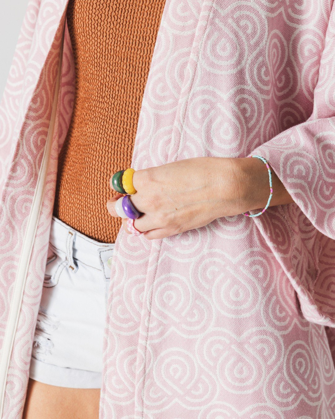 7. Close-up of Patulove rose bamboo kimono showing spiral pattern and colorful accessories