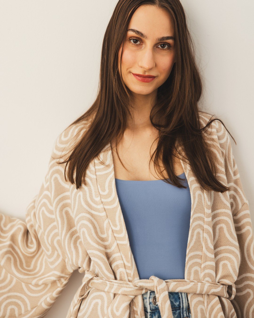 6. Close-up of woman in Patulove sand kimono with blue top, smiling