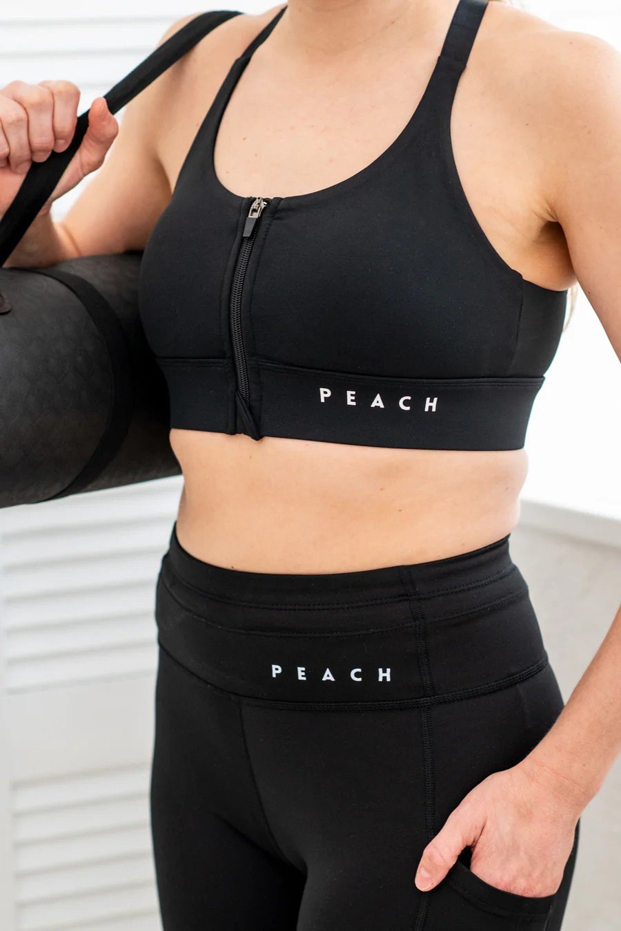 3. Close-up of Peachlabel PocketPerfect Inky Black leggings with side pocket detail and brand logo