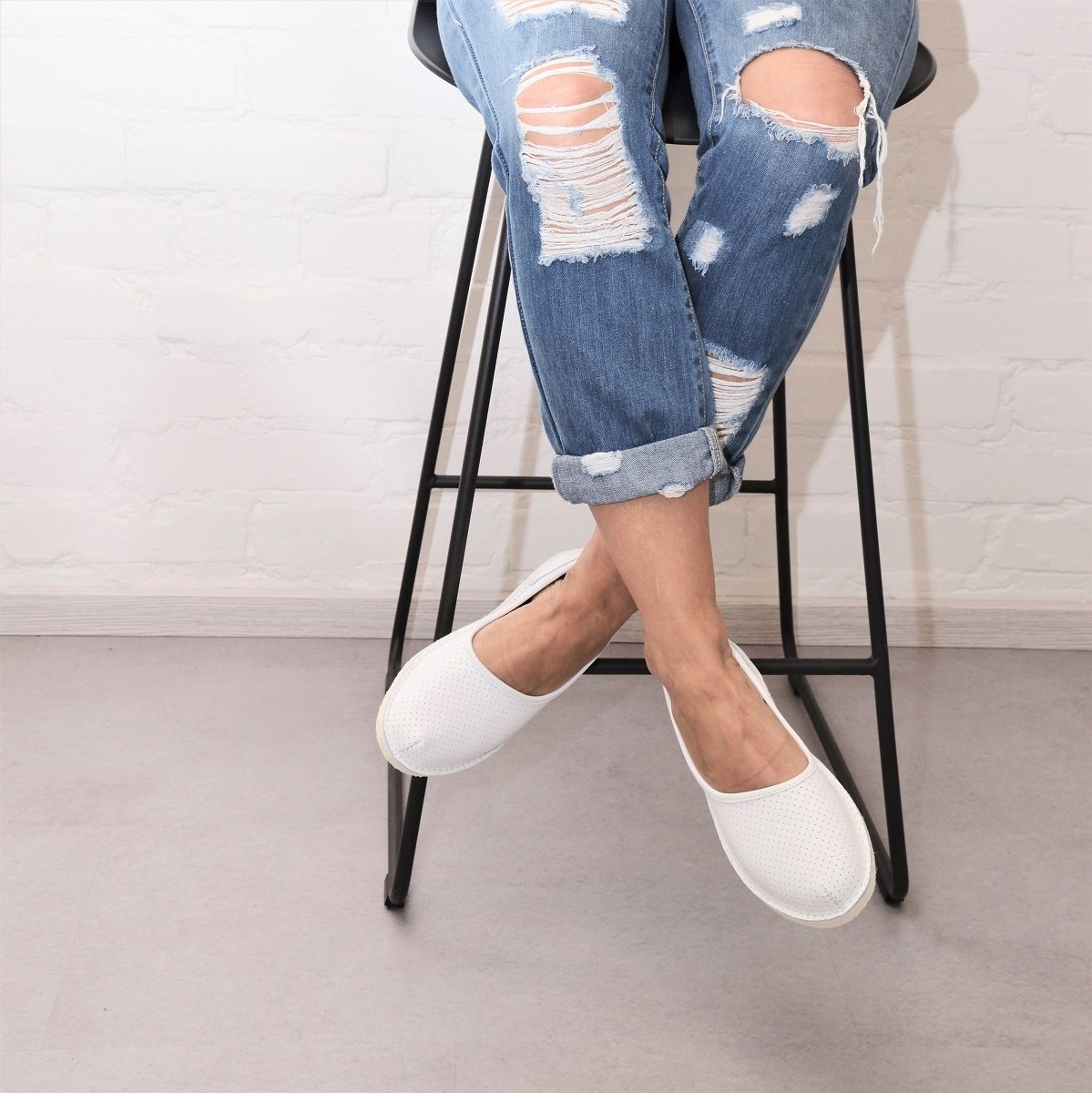 1. Women's Kuutsid Shoes in white by OmaKing, worn with ripped jeans, showcasing urban style and comfort