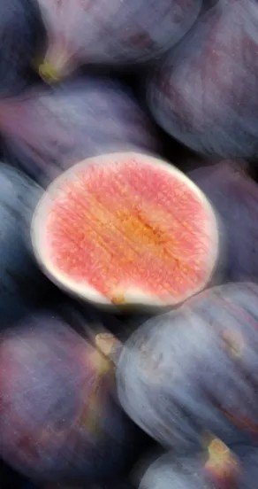 3. Close-up of ripe figs with one cut open showing pink interior