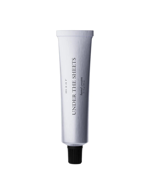 1. Aluminum tube of maar Under The Sheets hand cream with black cap on white background