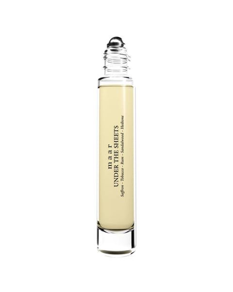 1. maar Under The Sheets perfume oil in clear glass roll-on bottle with black cap, featuring saffron, tobacco, and rum notes