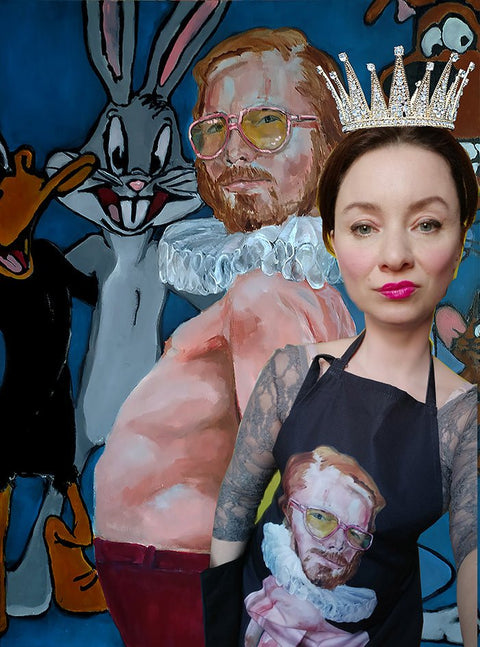 1. Woman wearing Katrin Valgemäe's 'Pervert in the Kitchen' apron with pop art design, standing in front of a colorful cartoon mural