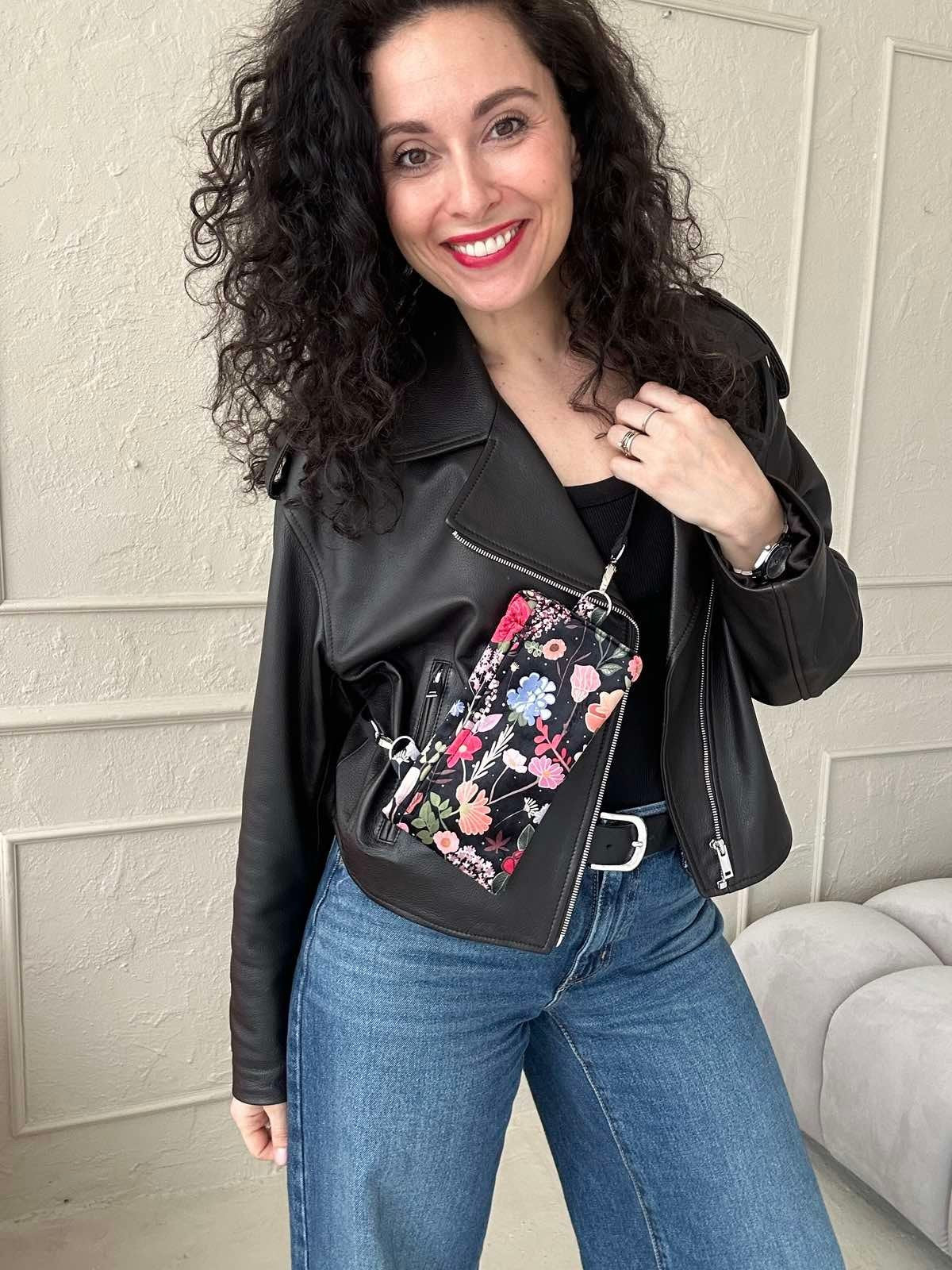 1. Woman wearing Garbanota Curly Summer Night phone bag with floral design, styled with black leather jacket and jeans