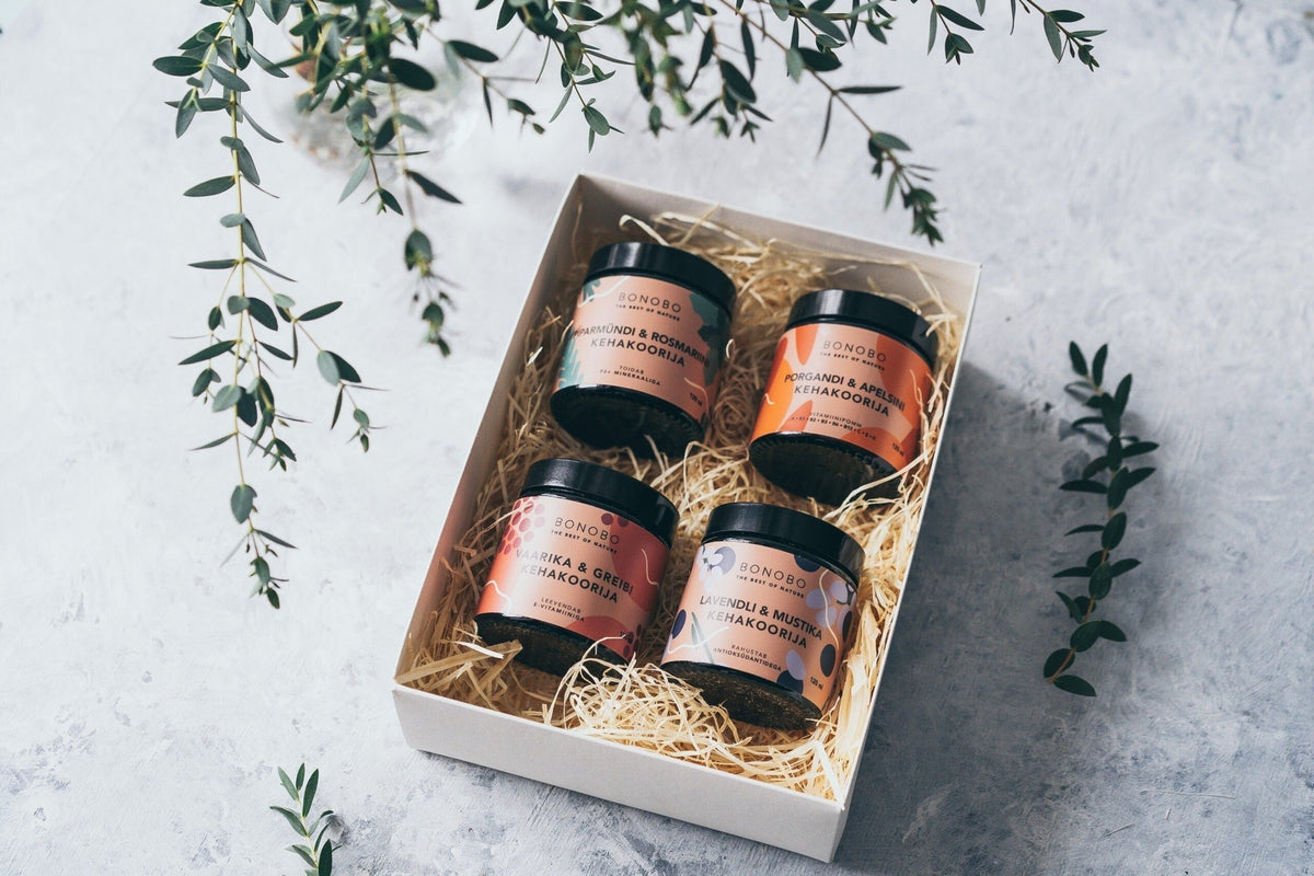 1. BONOBO Piece of Heaven gift box with four body scrubs in a white box on a textured surface with greenery