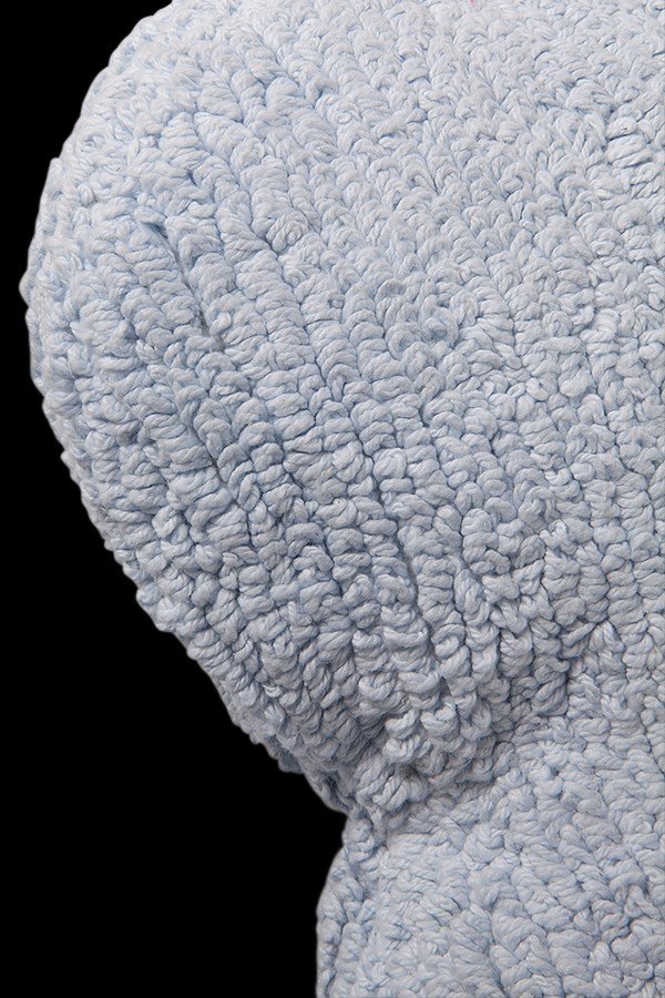 4. Close-up of textured cotton fabric on blue cloud-shaped pillow highlighting material detail