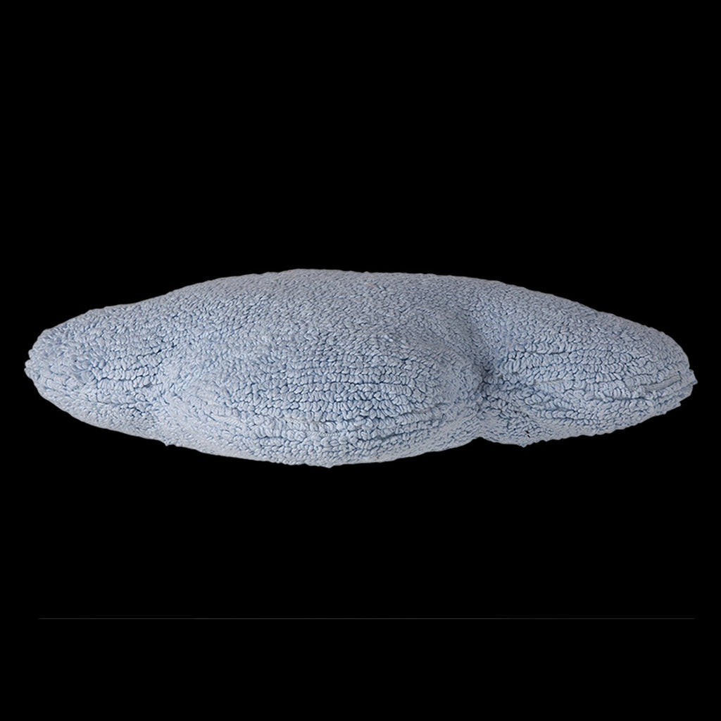 3. Side view of blue cloud-shaped pillow showing textured cotton fabric against a black background