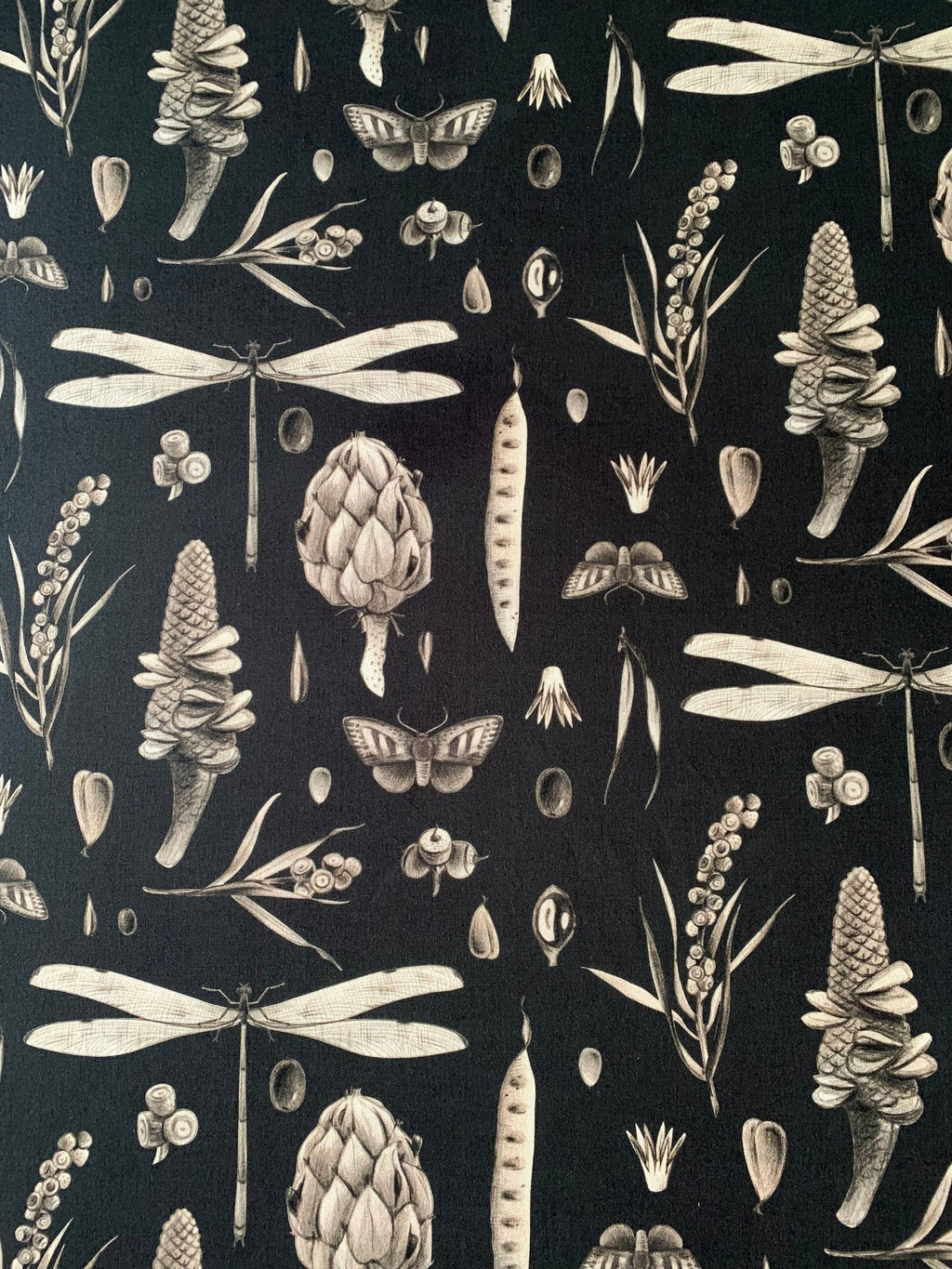 2. Close-up of Seeds Carbon print on pillowcase showing detailed botanical and insect illustrations on black cotton fabric