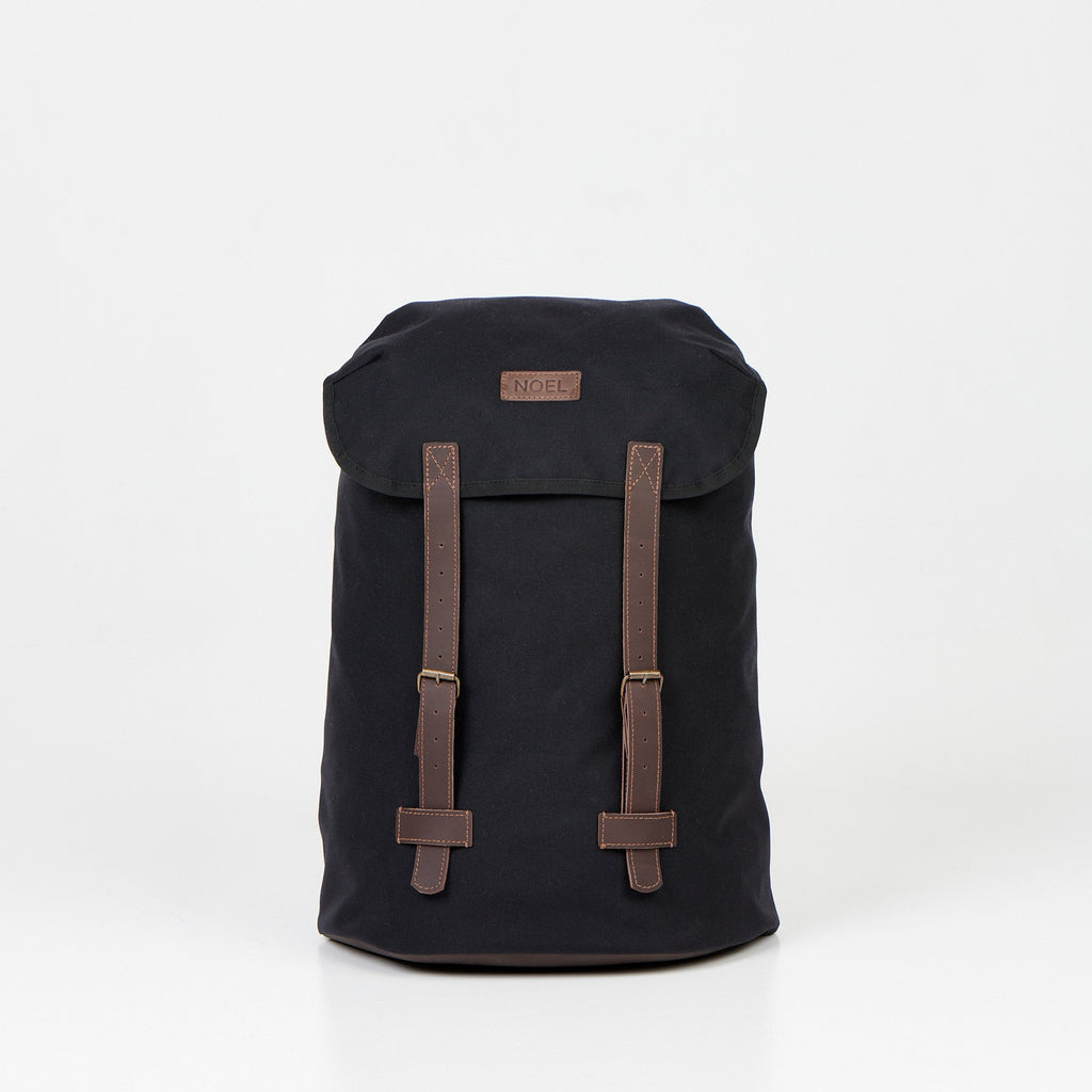 1. Noel Cafe Handmade Backpack in black Cordura, front view with brown straps, studio setting
