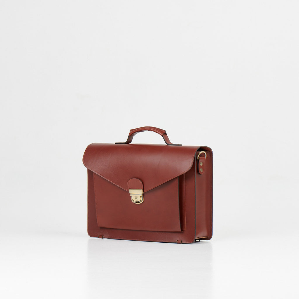 3. Side angle of Papillon Briefcase No. 36 in cognac leather, showing clasp detail, studio setting