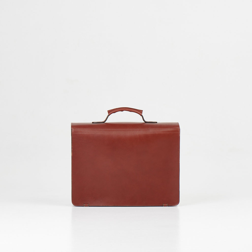 5. Back view of Papillon Briefcase No. 36 in cognac leather, studio setting