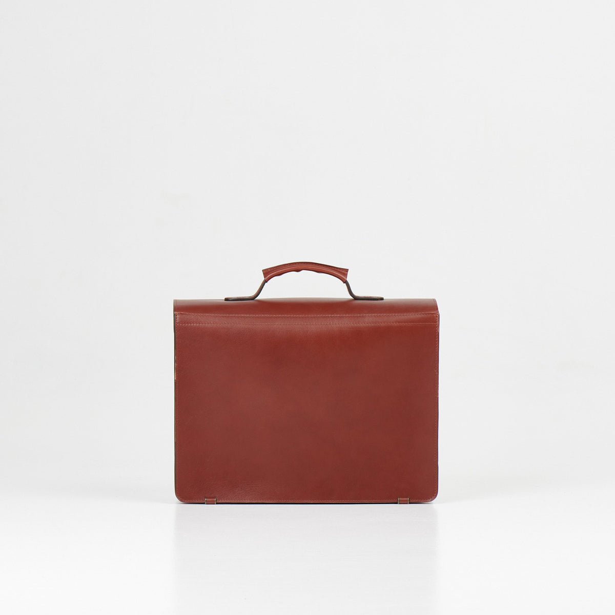 5. Back view of Papillon Briefcase No. 36 in cognac leather, studio setting