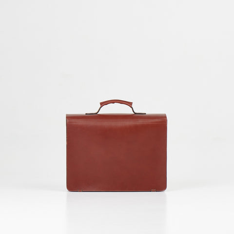 5. Back view of Papillon Briefcase No. 36 in cognac leather, studio setting
