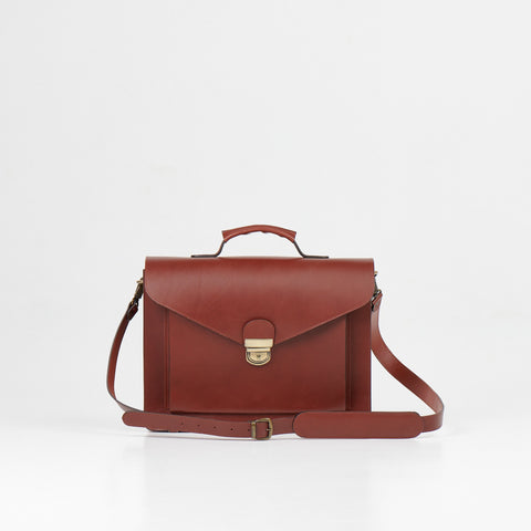 1. Papillon Briefcase No. 36 in cognac leather with adjustable shoulder strap, studio setting