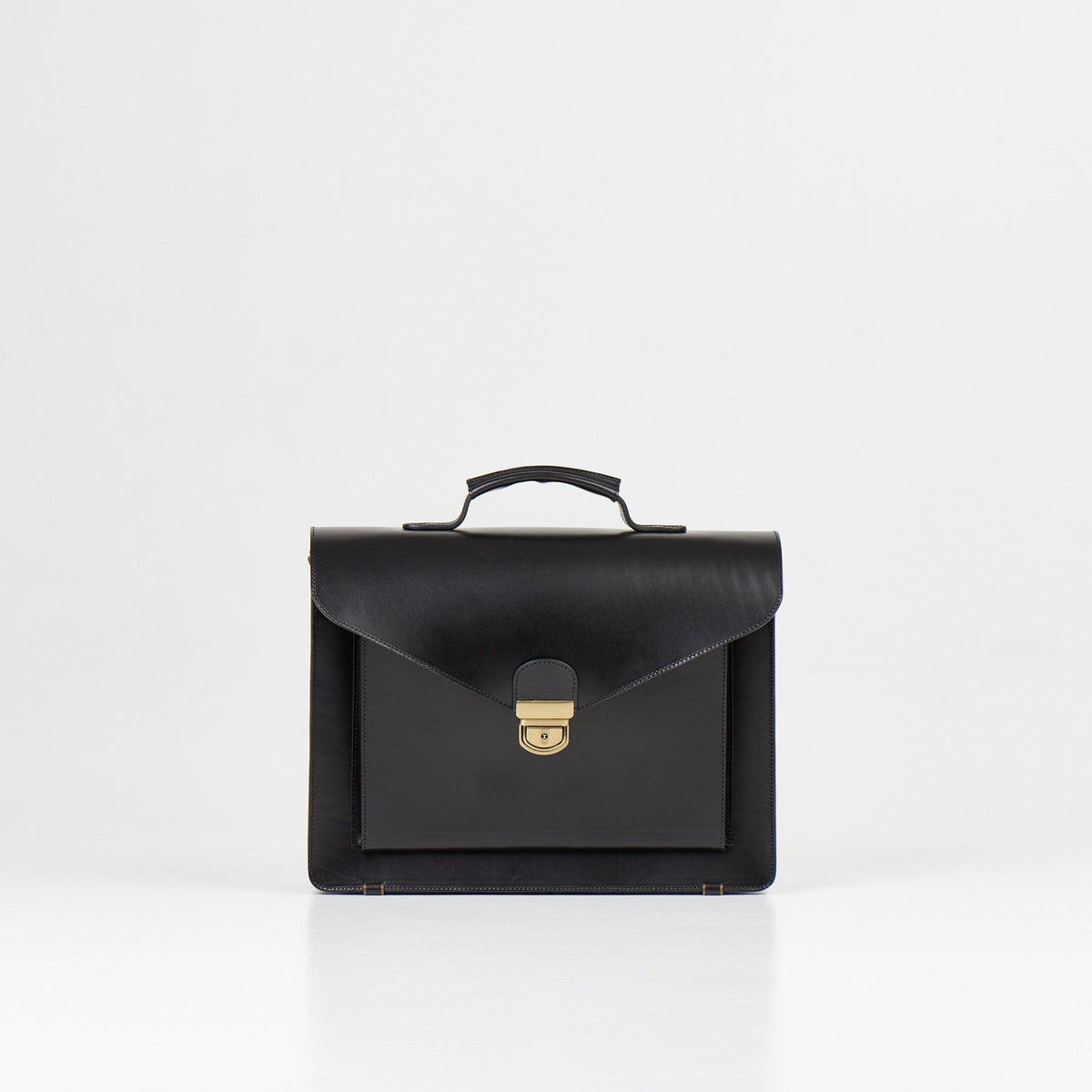 1. Papillon Briefcase No. 36 in black full-grain leather, front view with handle, studio setting