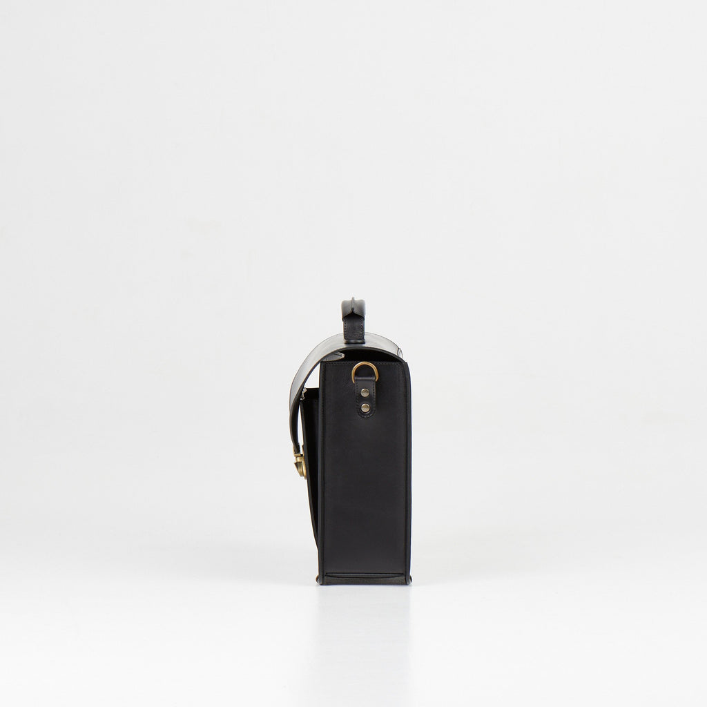3. Side view of Papillon Briefcase No. 36 in black leather, highlighting thickness and handle, studio setting