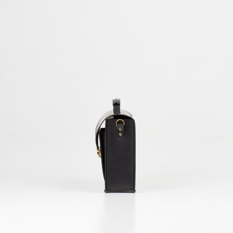 3. Side view of Papillon Briefcase No. 36 in black leather, highlighting thickness and handle, studio setting