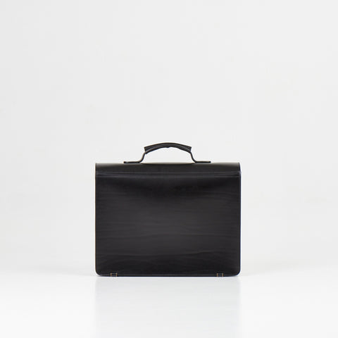 4. Back view of Papillon Briefcase No. 36 in black leather, showing smooth finish, studio setting