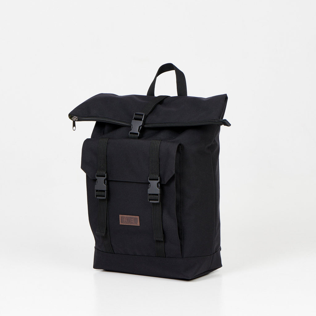 3. Side angle of Noel Cliff 25L black backpack highlighting front pocket and buckle details
