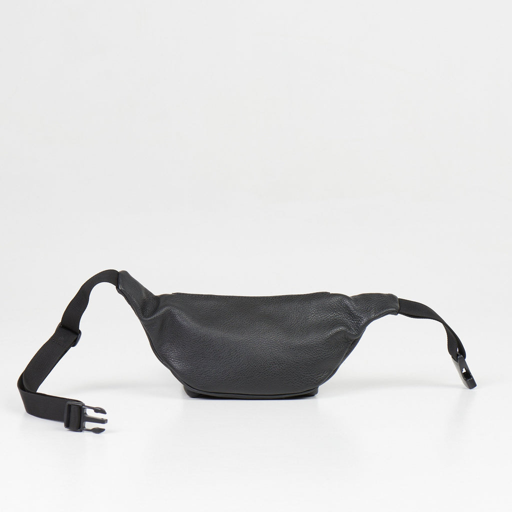 4. Flat lay of black leather waist bag with adjustable strap and buckle on white background